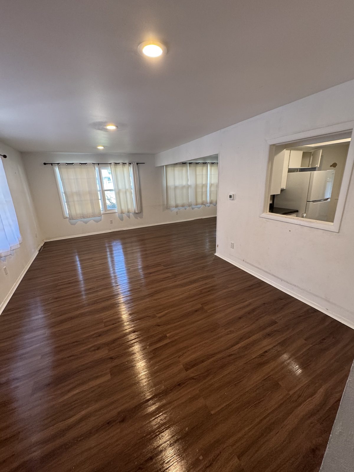 Vacant unit with hardwood floors cleaned for move-in
