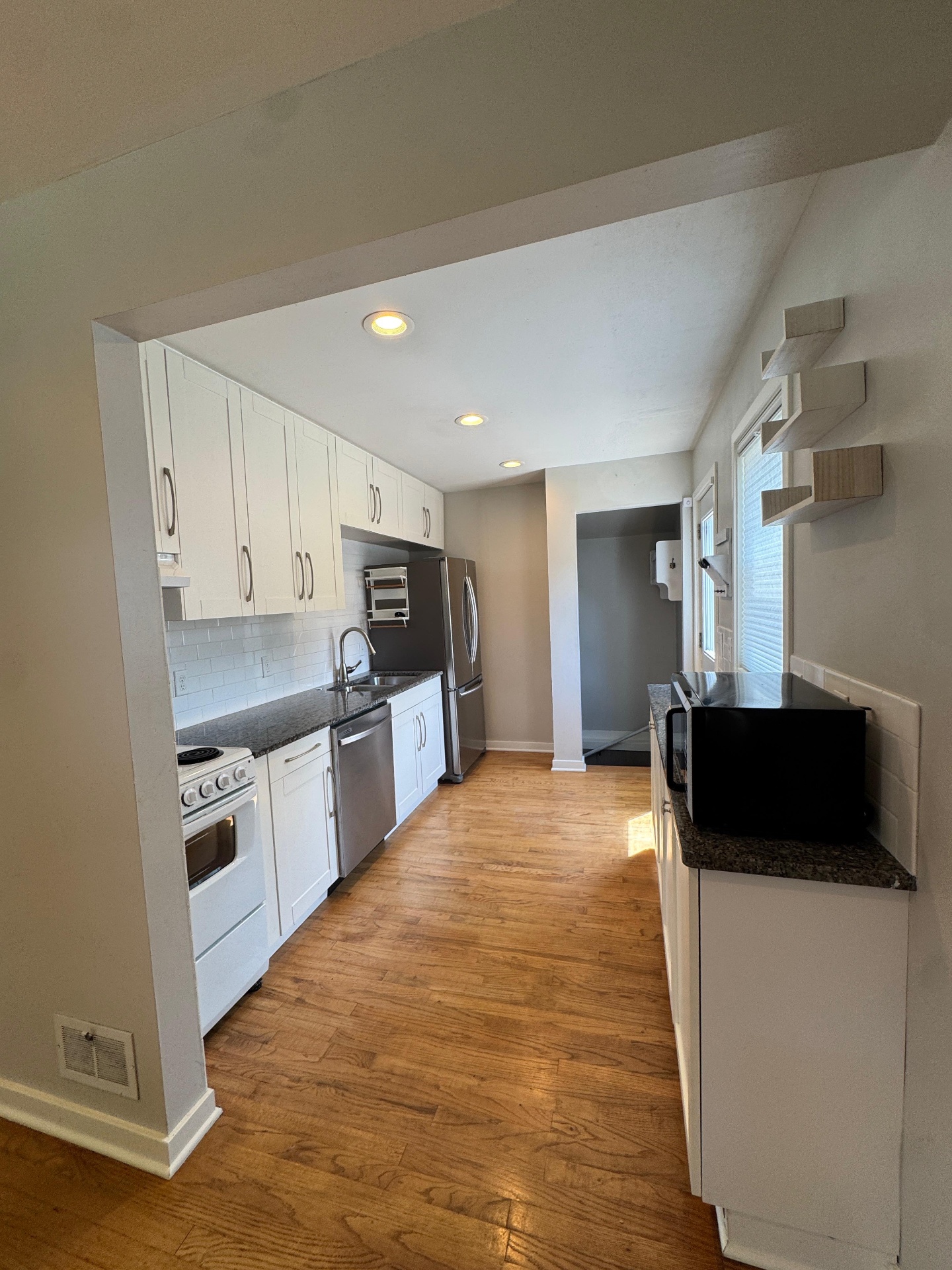 Bright modern kitchen with hardwood floors cleaned by IBS in Madison, WI