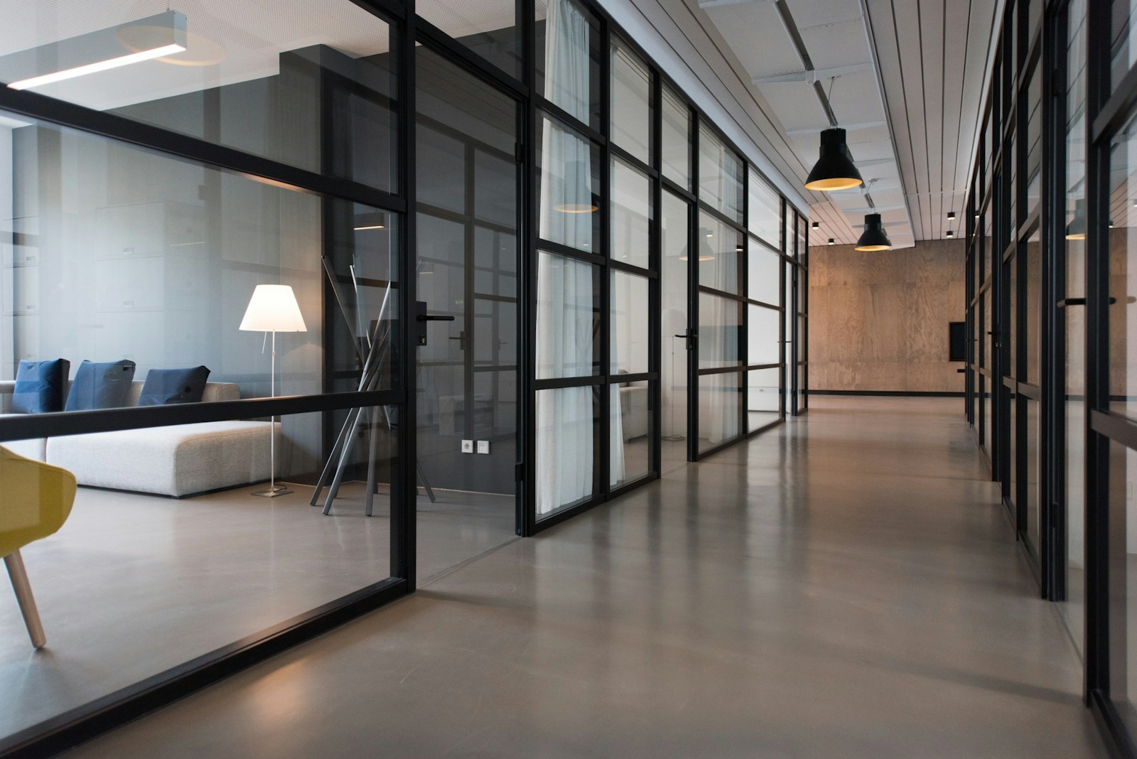 Clean modern office hallway with glass partitions